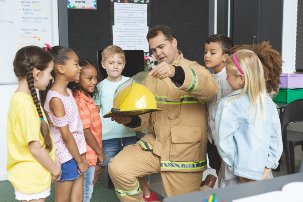 a firefighter showing school children his equipment.
