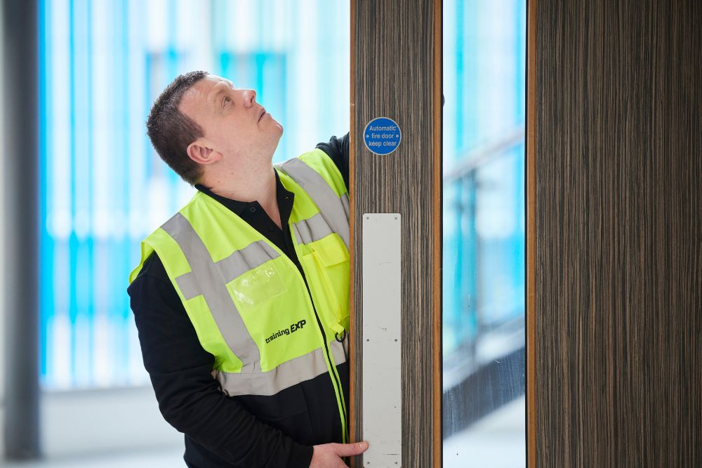 man looking and inspecting a fire door